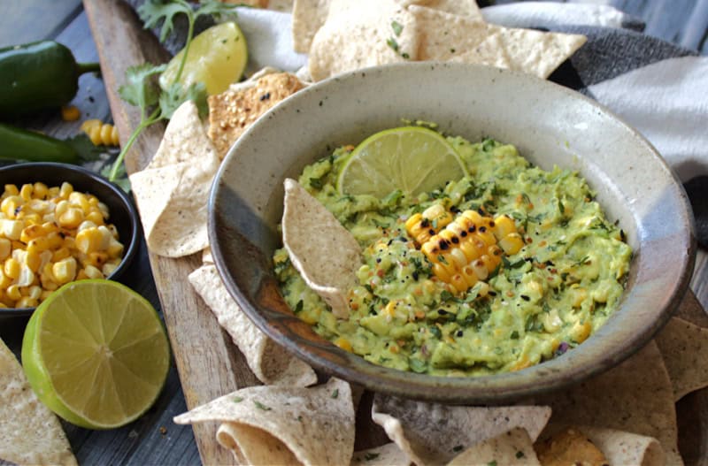 gray bowl with charred corn guacamole garnished with cilantro
