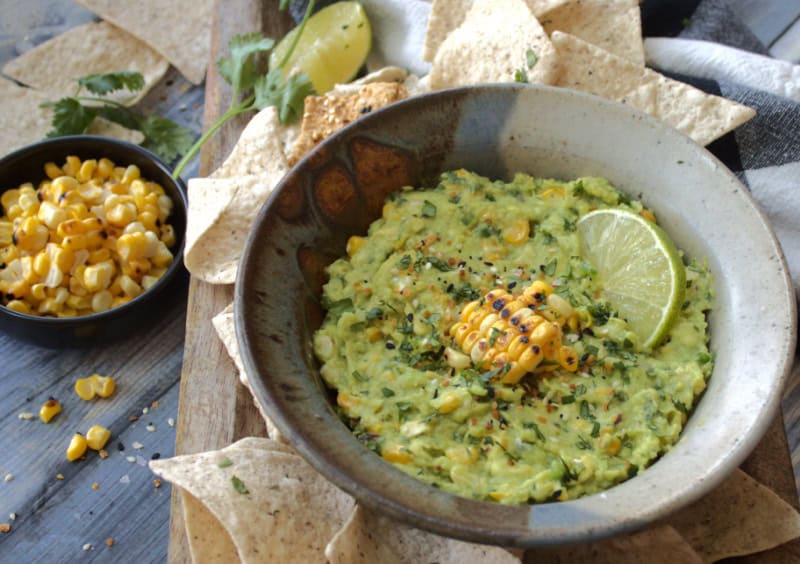 gray bowl with charred corn guacamole garnished with cilantro