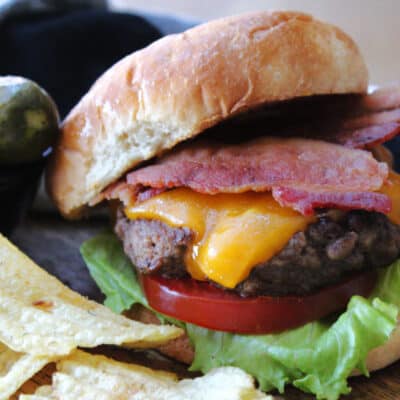 closeup of the best cheeseburger recipe topped with bacon and toasted bun