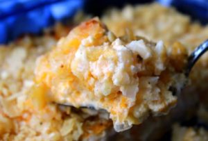 closeup scoop of cheesy potatoes