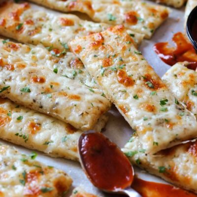 sliced of cheesy breadsticks garnished with parsley