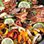 overhead view of chicken fajitas , peppers and onions in a skillet - what to serve with fajitas