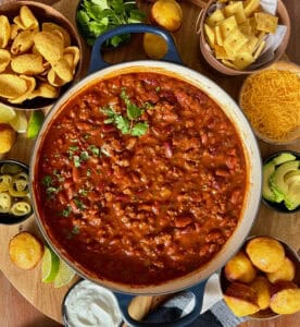 pot of chili for chili bar surrounded by toppings
