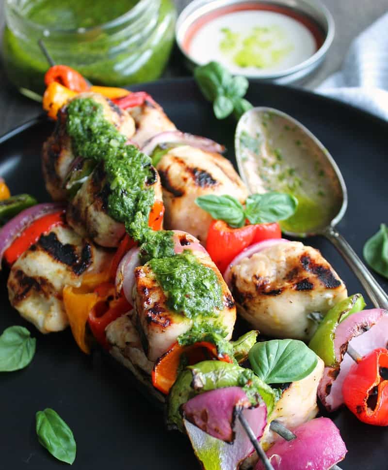 grilled chicken skewers with basil chimichurri drizzled over top