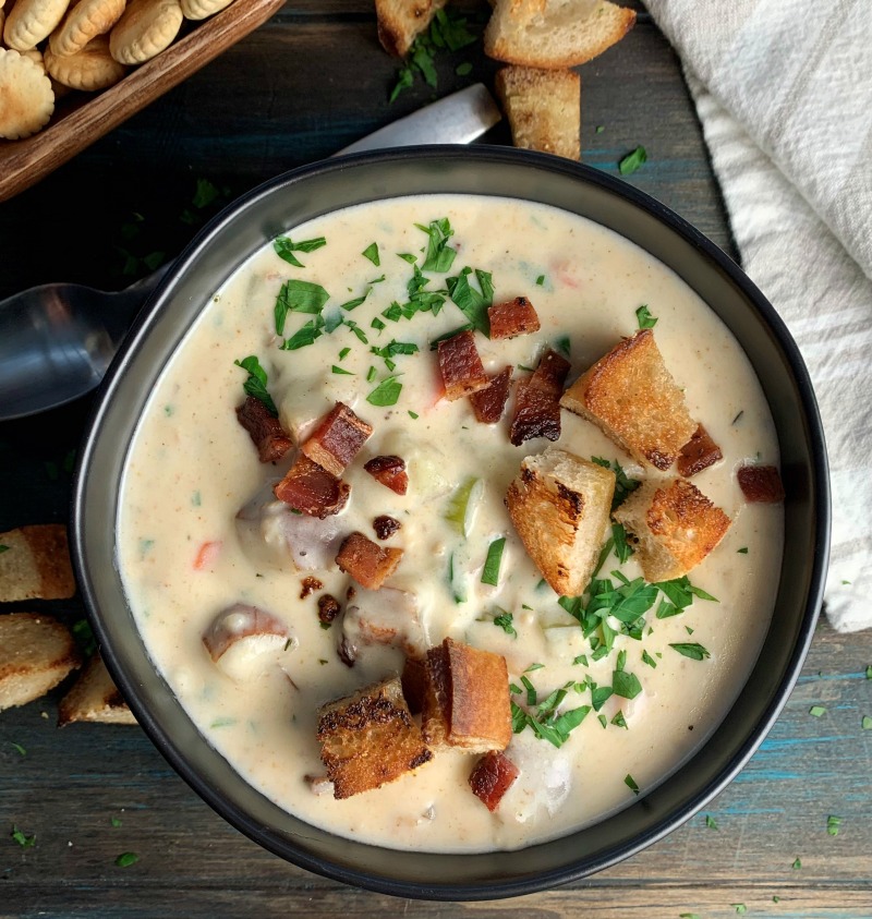 overhead view of bowl of new england clam chowder garnished with toasted croutons