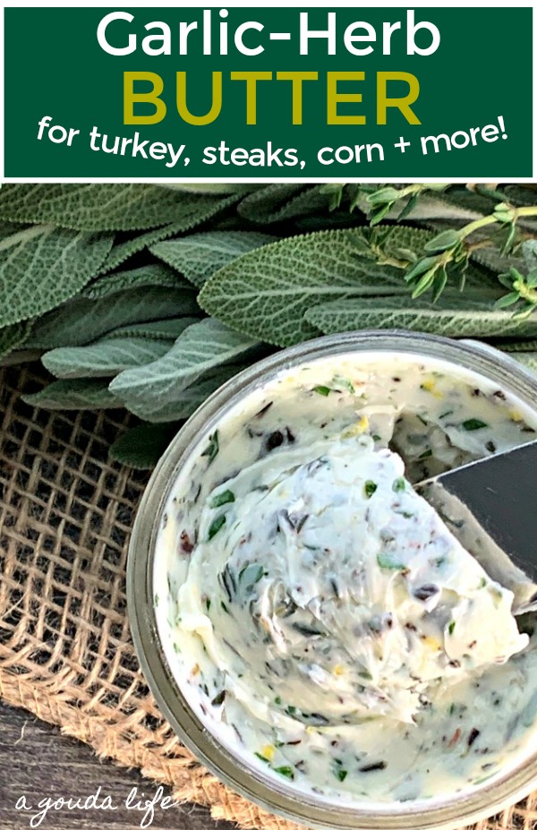 pinterest pin showing jar with garlic herb butter surrounded by fresh herbs