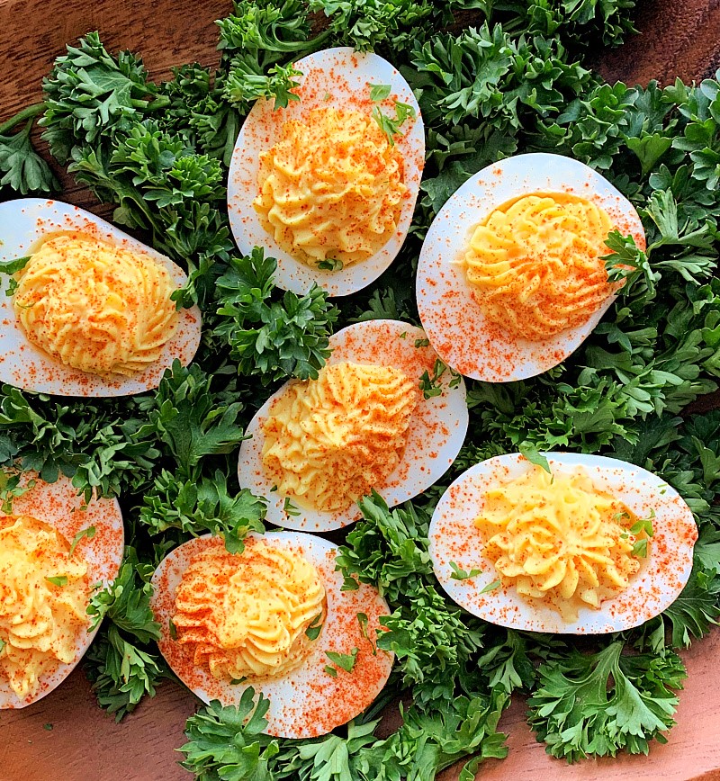 deviled eggs surrounded by chopped parsley