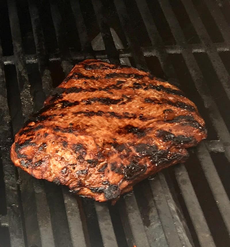 flank steak on the grill showing sear marks