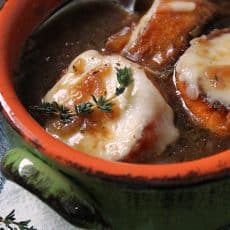 French Onion Soup ~ classic soup loaded with caramelized onions + a rich, flavor-packed beef-wine broth. Top with toasted croutons and gooey melted cheese.