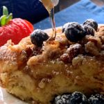 french toast casserole with syrup drizzled on top