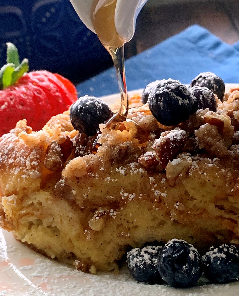 french toast casserole with syrup drizzled on top