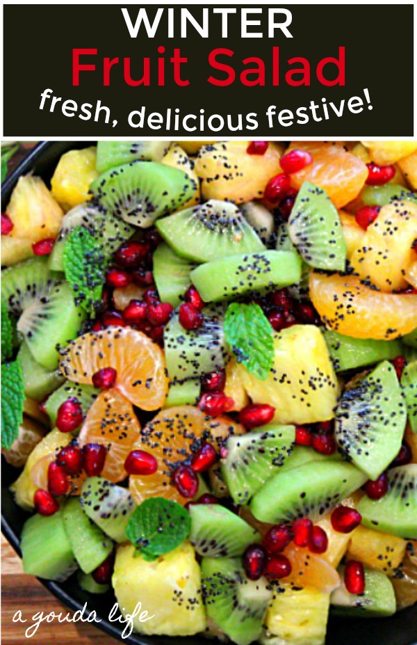 pinterest pin showing winter fruit salad of pomegranate,clementines, pineapple and kiwi