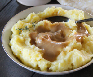 white bowl with mashed potatoes and gravy made without drippings