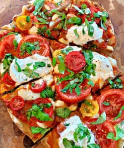 how to grill pizza - margharita pizza shown garnished with basil