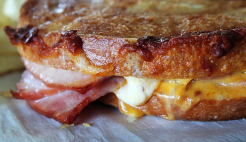 closeup of grilled air fryer ham and cheese sandwich