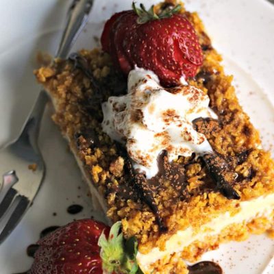 Easy Fried Ice Cream Cake ~ vanilla ice cream with a crispy honey-cinnamon coating drizzled with fudge and topped with whipped cream and fresh strawberries.