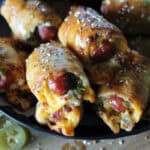 bowl of baked jalapeno popper pigs in a blanket sprinkled with Everything Bagel seasoning