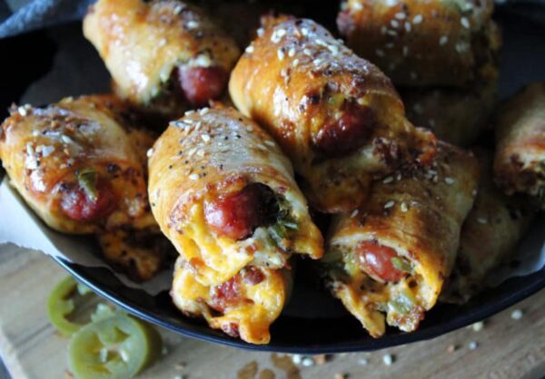 bowl of baked jalapeno popper pigs in a blanket sprinkled with Everything Bagel seasoning