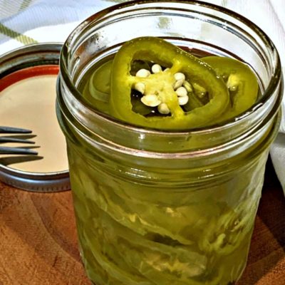 clear mason jar with pickled jalapenos