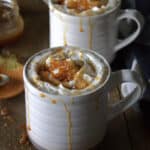 2 mugs with caramel creme brulee latte and jar of caramel