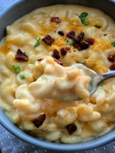 bowl of loaded mac and cheese with spoonful lifted out