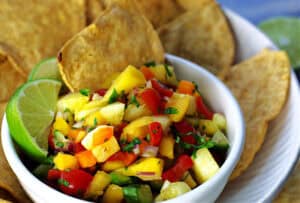 Pineapple Mango Salsa in white bowl with tortilla chips