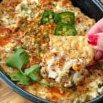 closeup of Mexican Street Corn Dip scooped on a tortilla chip