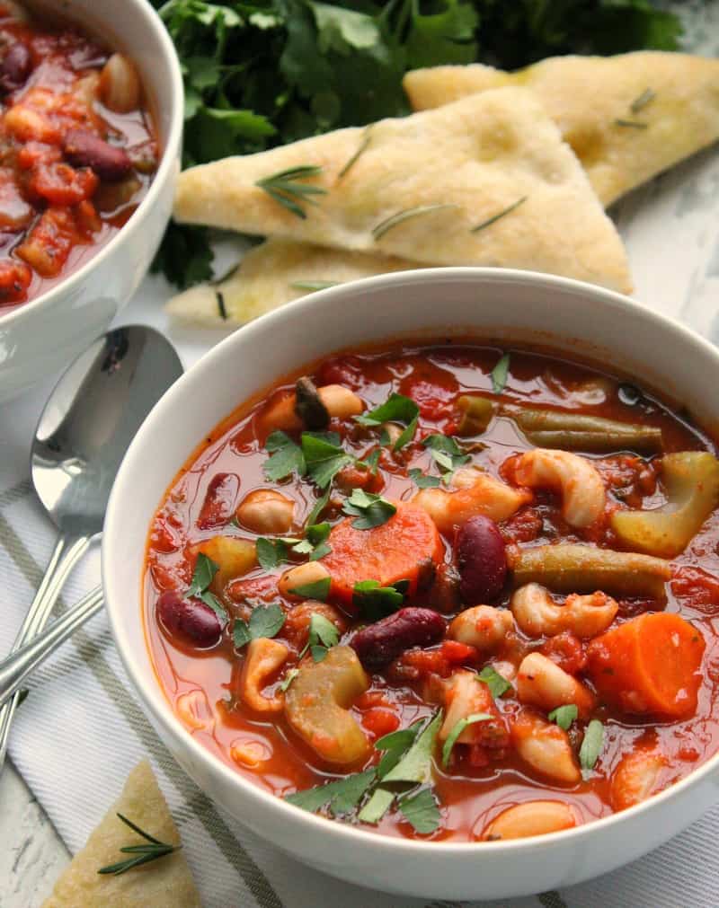 best sides with minestrone soup - bowl of minestrone soup with focaccia bread