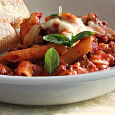 Baked Mostaccioli ~ blanketed in layers of robust tomato flavor, 3 cheeses and baked. Easy prep and a great dish for a crowd.