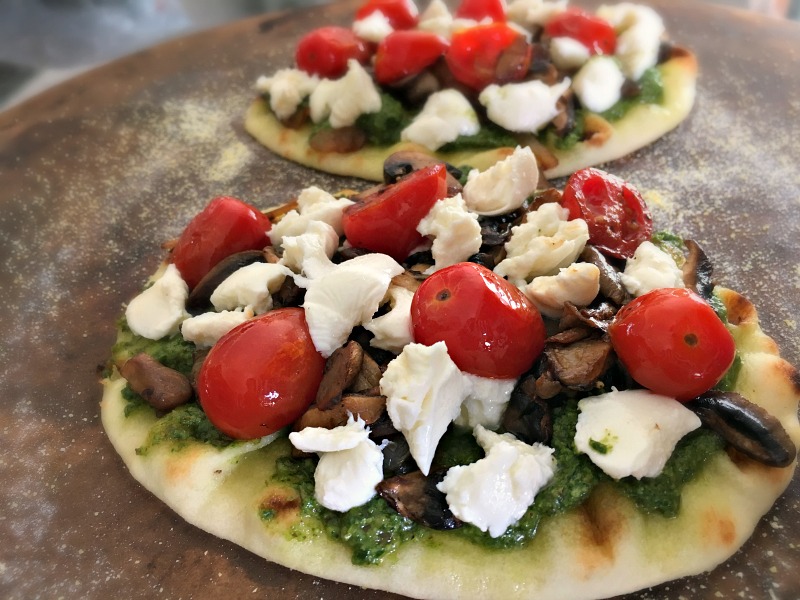 Wild Mushroom Pizza recipe. Naan crust topped with pesto, wild mushrooms, tomatoes and fresh mozzarella. Easy, delicious any night meal.