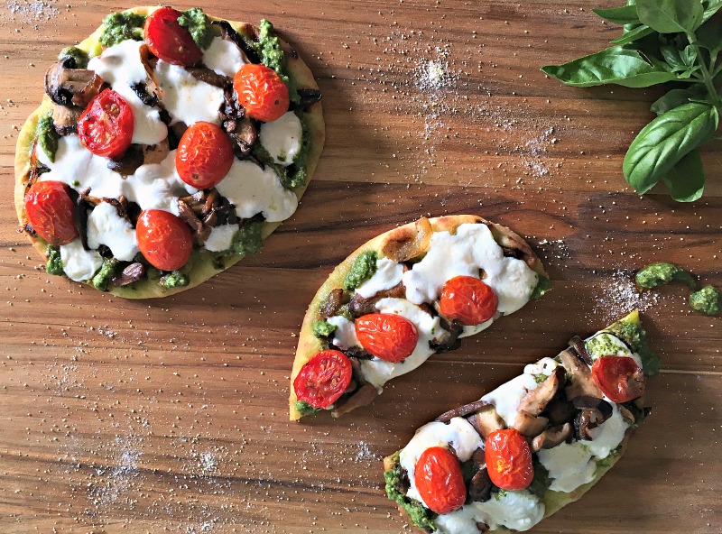 Wild Mushroom Pizza recipe. Naan crust topped with pesto, wild mushrooms, tomatoes and fresh mozzarella. Easy, delicious any night meal.