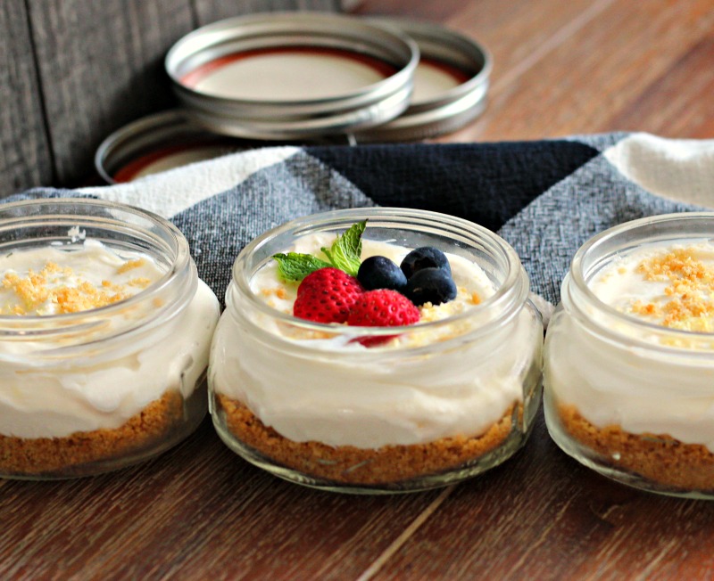 No Bake Cheesecake Jars topped with strawberries and blueberries