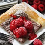 white plate with nutella puff pastry topped with raspberry sauce