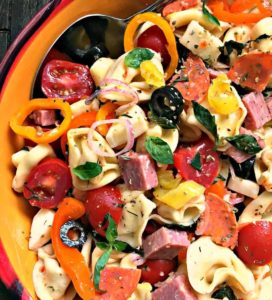 italian pasta salad ~ tortellini antipasto salad overhead view in colorful bowl