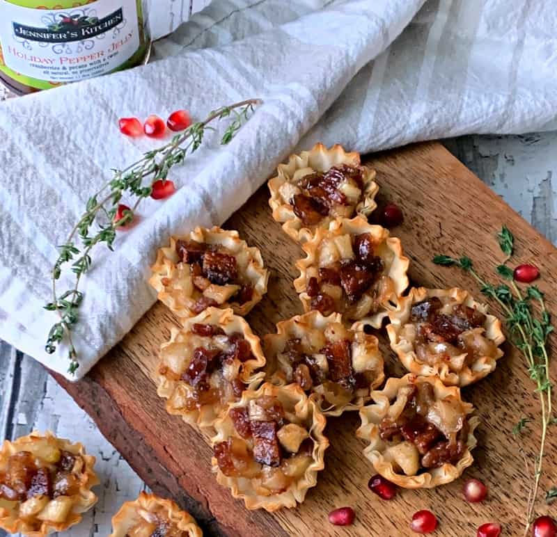 overhead view of apple filled phyllo cups with jar of jelly in the background