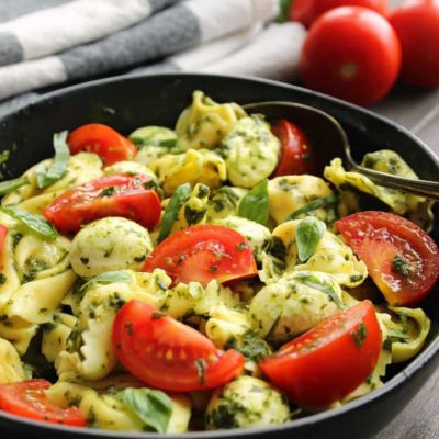 tortellini, sliced tomatoes and mozzarella balls tossed in pesto