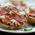 closeup of air fryer pizzza bagel bites on white plate