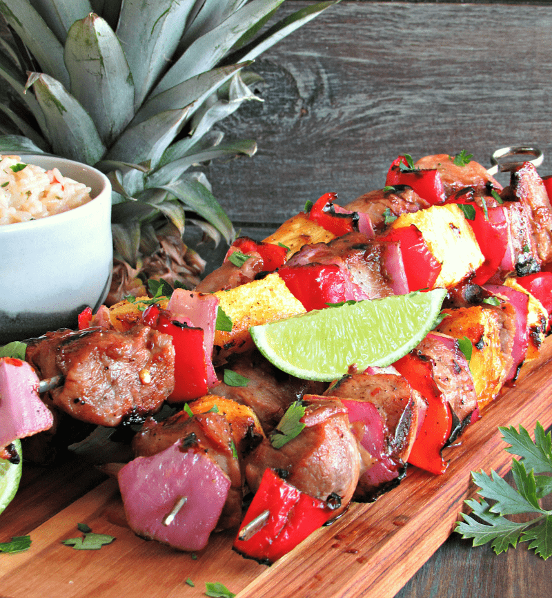 Grilled Teriyaki Rum Pork Kabobs: teriyaki-rum-citrus marinated pork is skewered with fresh pineapple, red onions and peppers and grilled.