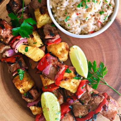 Grilled Teriyaki Rum Pork Kabobs: teriyaki-rum-citrus marinated pork is skewered with fresh pineapple, red onions and peppers and grilled.
