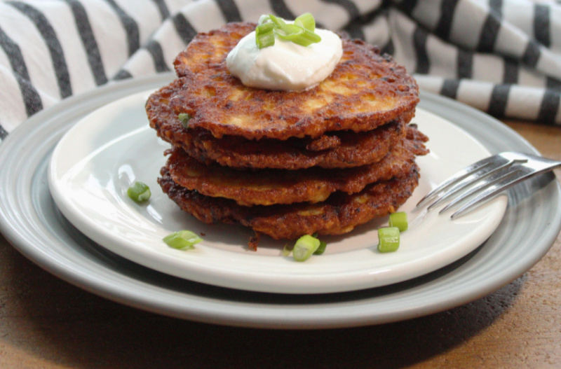 stack of polish potato pancakes with dollop of sour cream on top