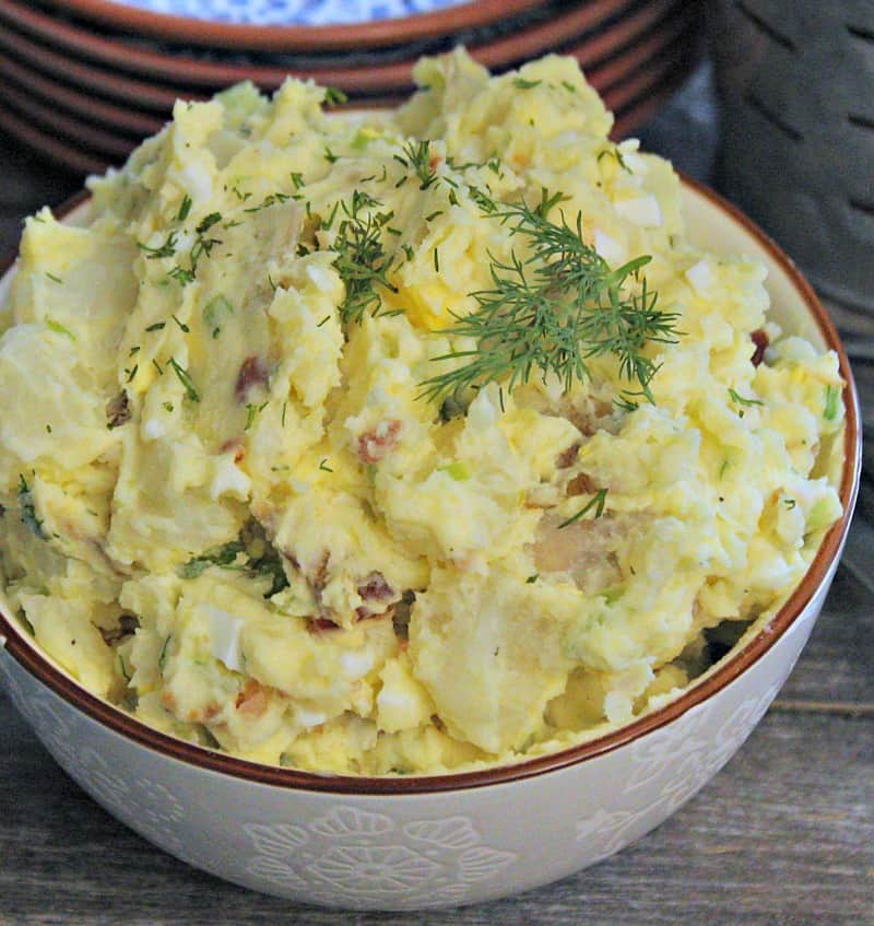 potato salad recipe - overview view of blended potato salad garnished with dill