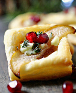 closeup fig goat cheese puff pastry with pomegranate seeds