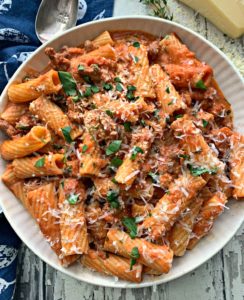 overhead view of sausage rigatoni garnished with parsley