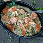 black casserole dish with baked salmon casserole garnished with crushed Ritz crackers