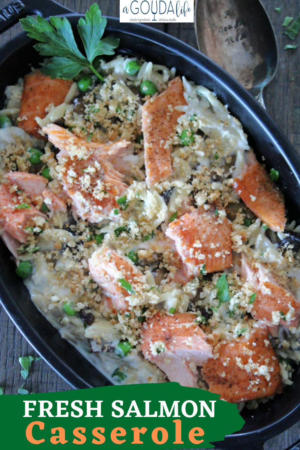 Salmon Casserole in black baking dish with toasted breadcrumbs