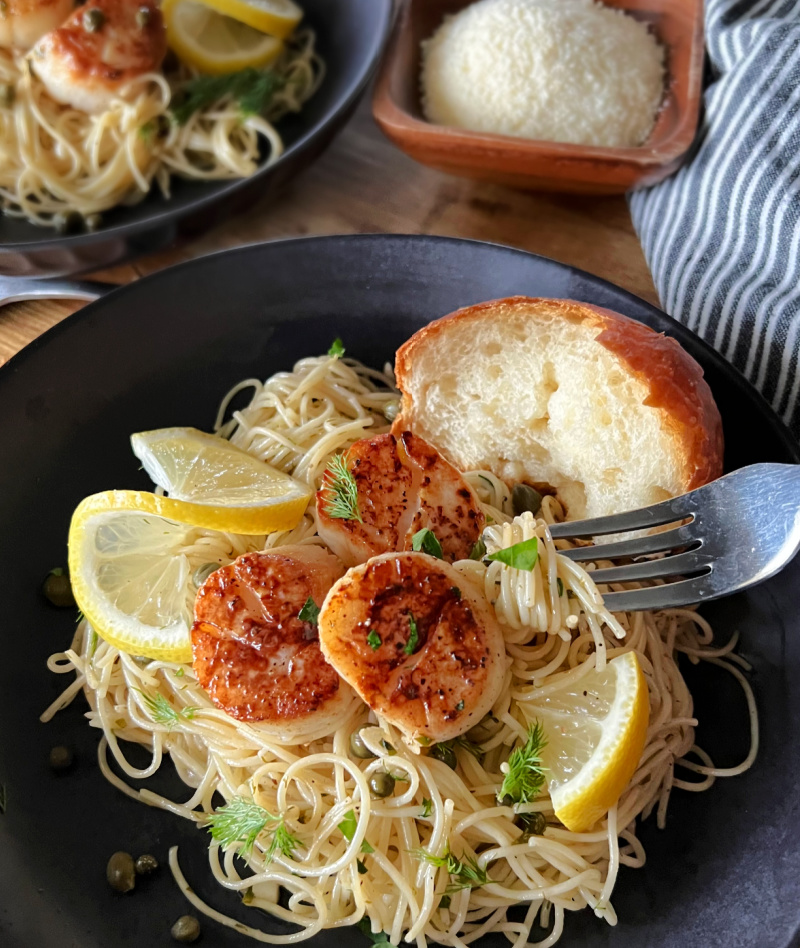 black with seafood pasta and crusty bread