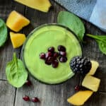 overhead view green smoothie garnished with pomegranate seeds