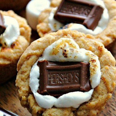 closeup of s'mores cookie cups with hershey bars in foreground