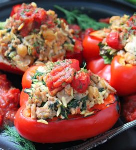 greek stuffed peppers ~ red bell peppers filled with greek seasoned ground turkey, feta, orzo, spinach and chickpeas baked in a Greek flavored tomato-herb sauce.