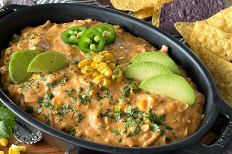 black casserole dish showing one of the best super bowl recipes, chicken enchilada dip